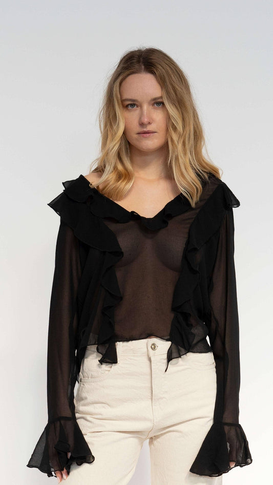 Blusa nera semitrasparente con volant