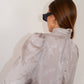 Blusa jacquard con collo alto e maniche a sbuffo