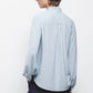 Blusa tinta unita con fiocco al collo