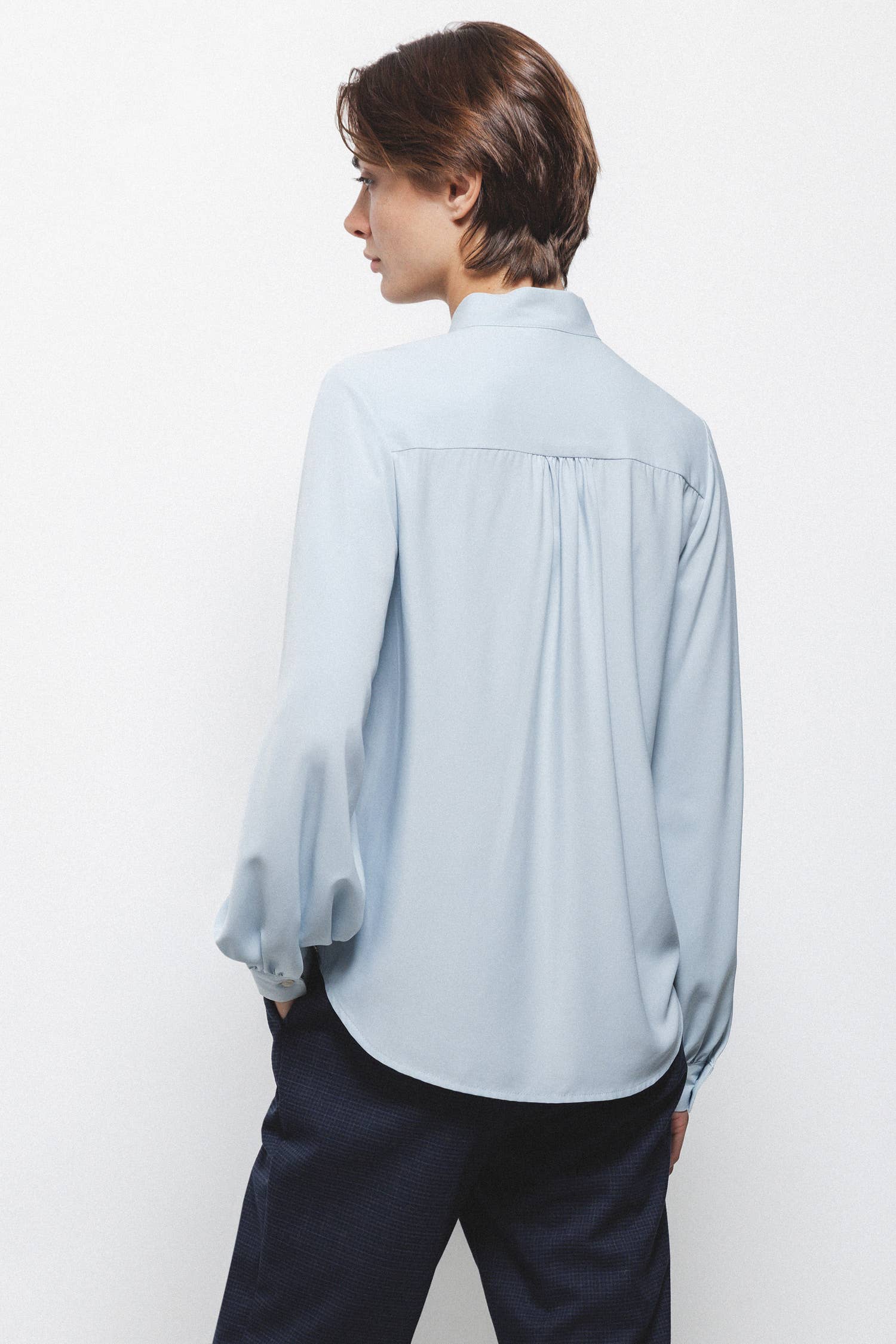 Blusa tinta unita con fiocco al collo