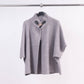 Cardigan smanicato con collo alto e fibbia decorativa