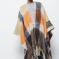 Poncho a quadri con frange
