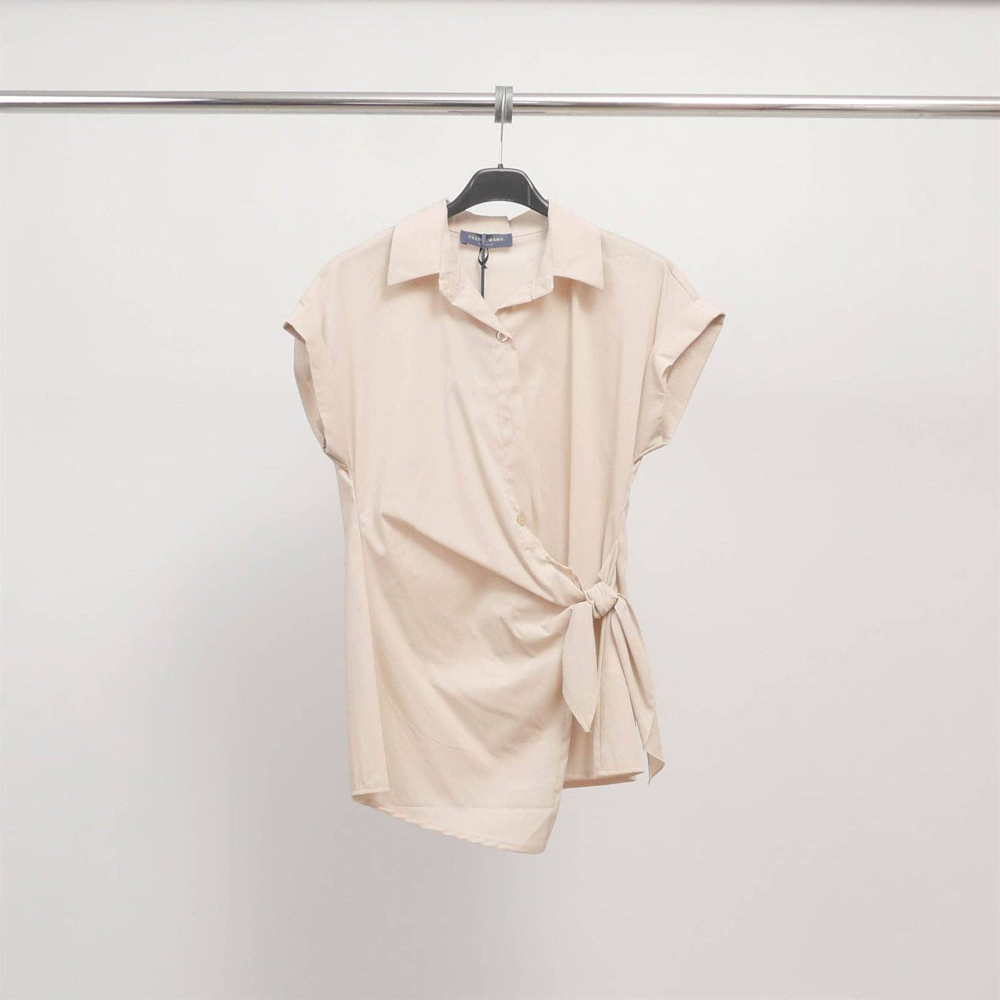 Camicia smanicata con collo sartoriale e nodo laterale
