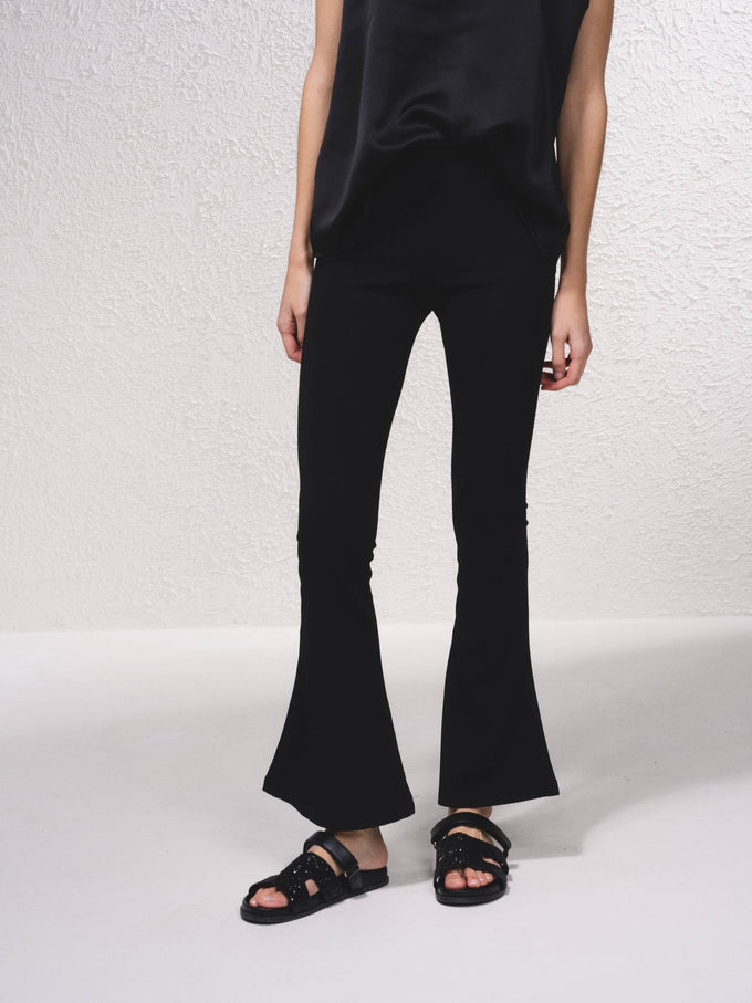 Pantaloni a zampa in rete con vita elasticizzata