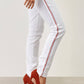 Pantaloni skinny bianchi con banda laterale