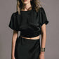 Top crop con maniche a palloncino e fiocco sul retro