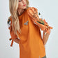 Top in cotone arancione con maniche a sbuffo floreali