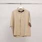 Cardigan smanicato con collo alto e fibbia decorativa