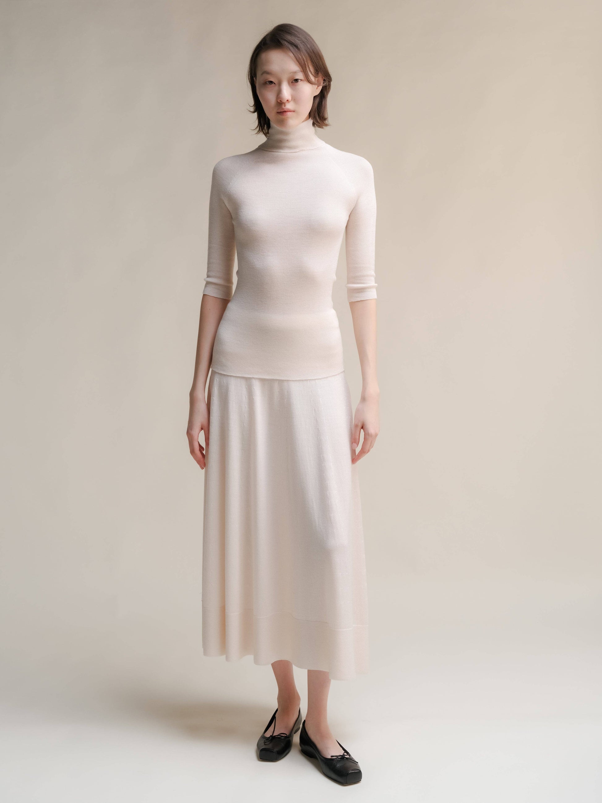 Dolcevita a coste in lana merino extrafine con manica 3/4