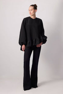 Blusa nera con balza asimmetrica