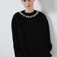 Maglione nero in maglia con perle applicate