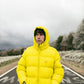 Piumino giallo in poliestere riciclato con cappuccio