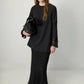 Tunica in crêpe nera con polsini in chiffon trasparente