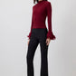 Blusa in maglia con maniche a balze in chiffon trasparente