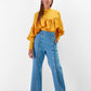 Blusa gialla con balze e pieghe sul petto