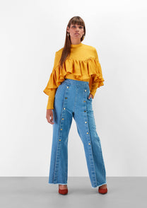Blusa gialla con balze e pieghe sul petto