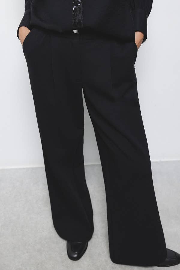 Pantaloni palazzo neri con piega frontale