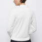 Maglione in maglia rasata con scollo a V e fiocco