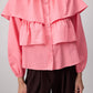 Blusa corta rosa con balze e maniche a sbuffo in misto cotone