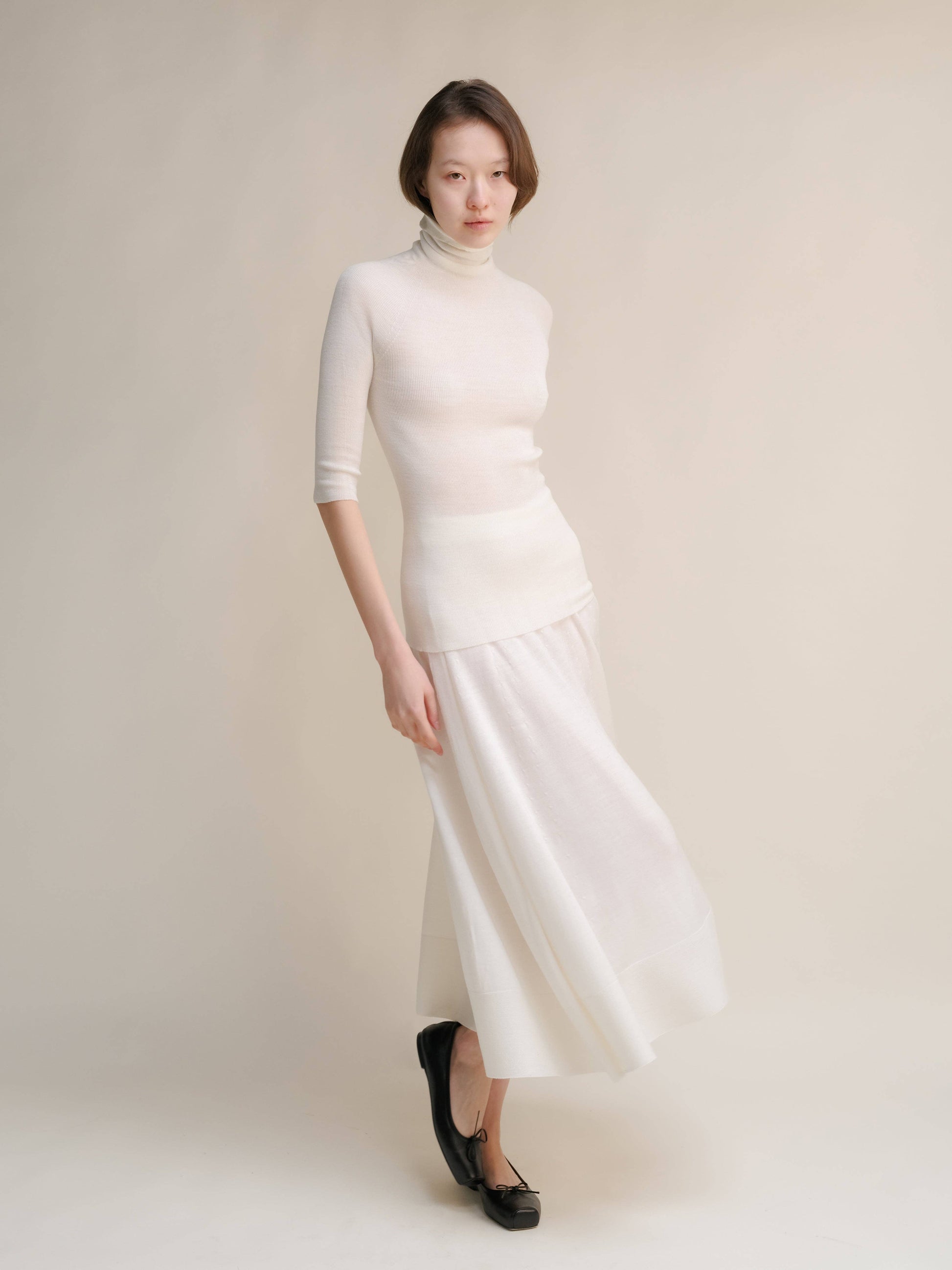Dolcevita a coste in lana merino extrafine con manica 3/4