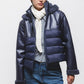 Giacca imbottita in eco-pelle con cappuccio e zip