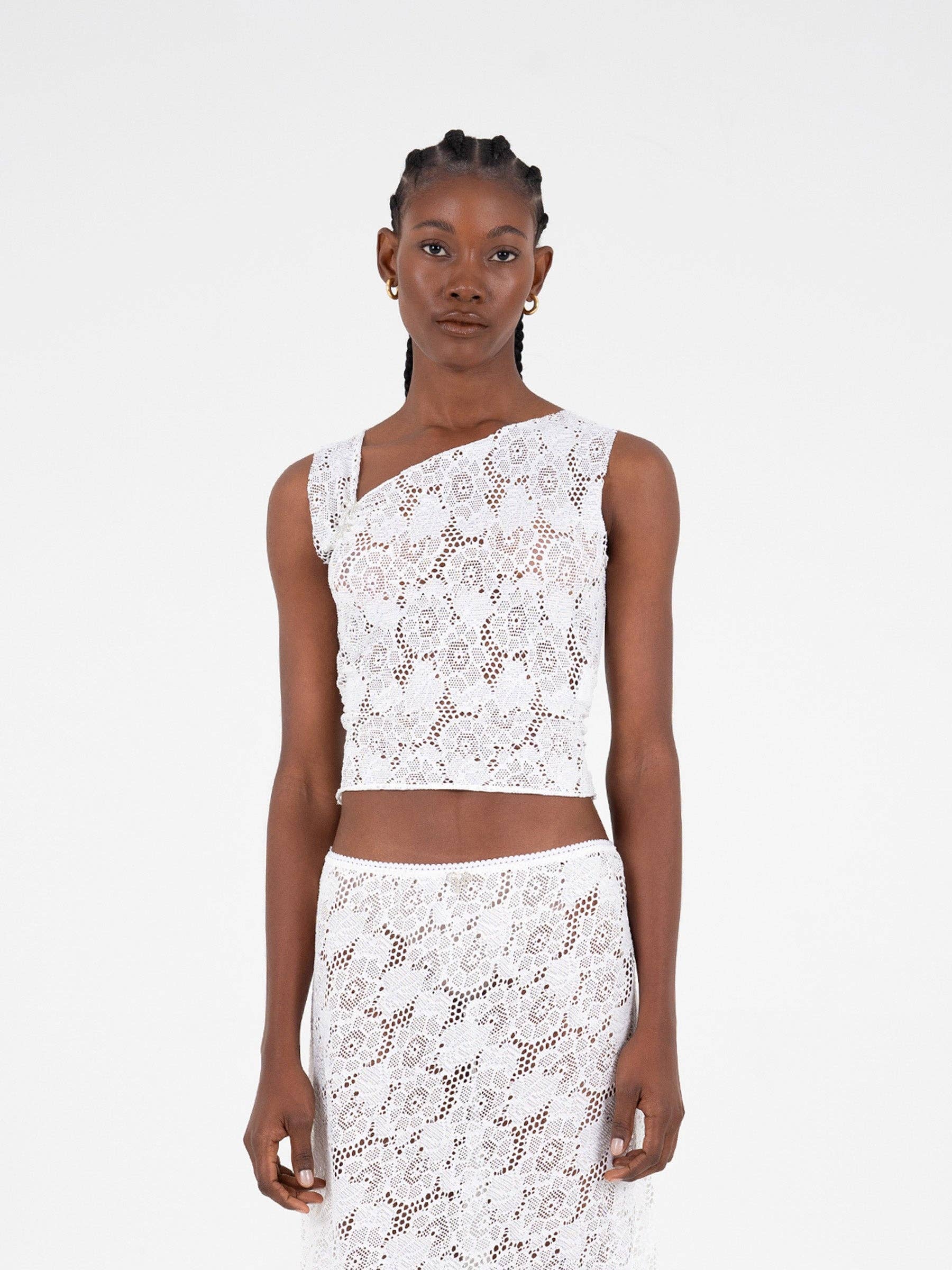 Top asimmetrico in pizzo bianco scintillante