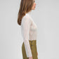 Top in pizzo bianco a maniche lunghe con collo alto