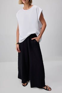 Pantaloni palazzo in cotone con dettagli sfrangiati