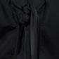 Top crop con maniche a palloncino e fiocco sul retro