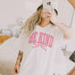T-shirt oversize grafica “Be Kind” con fiocco