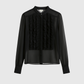 Blusa nera trasparente con volant