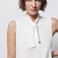 Top minimal con collo alto e fiocco