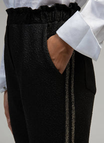 Pantaloni Pierroly effetto pelle neri con bande argento