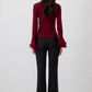 Blusa in maglia con maniche a balze in chiffon trasparente