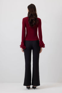 Blusa in maglia con maniche a balze in chiffon trasparente