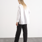 Camicia bianca in cotone con bottone a cuore