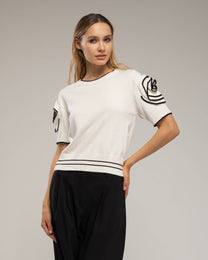 Maglia in cotone a righe con schiena aperta e fiocchi