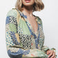 Blusa patchwork multicolor con scollo a V