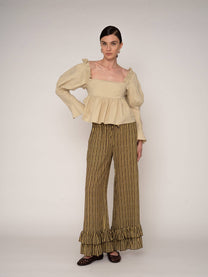 Blusa beige con volant e schiena aperta