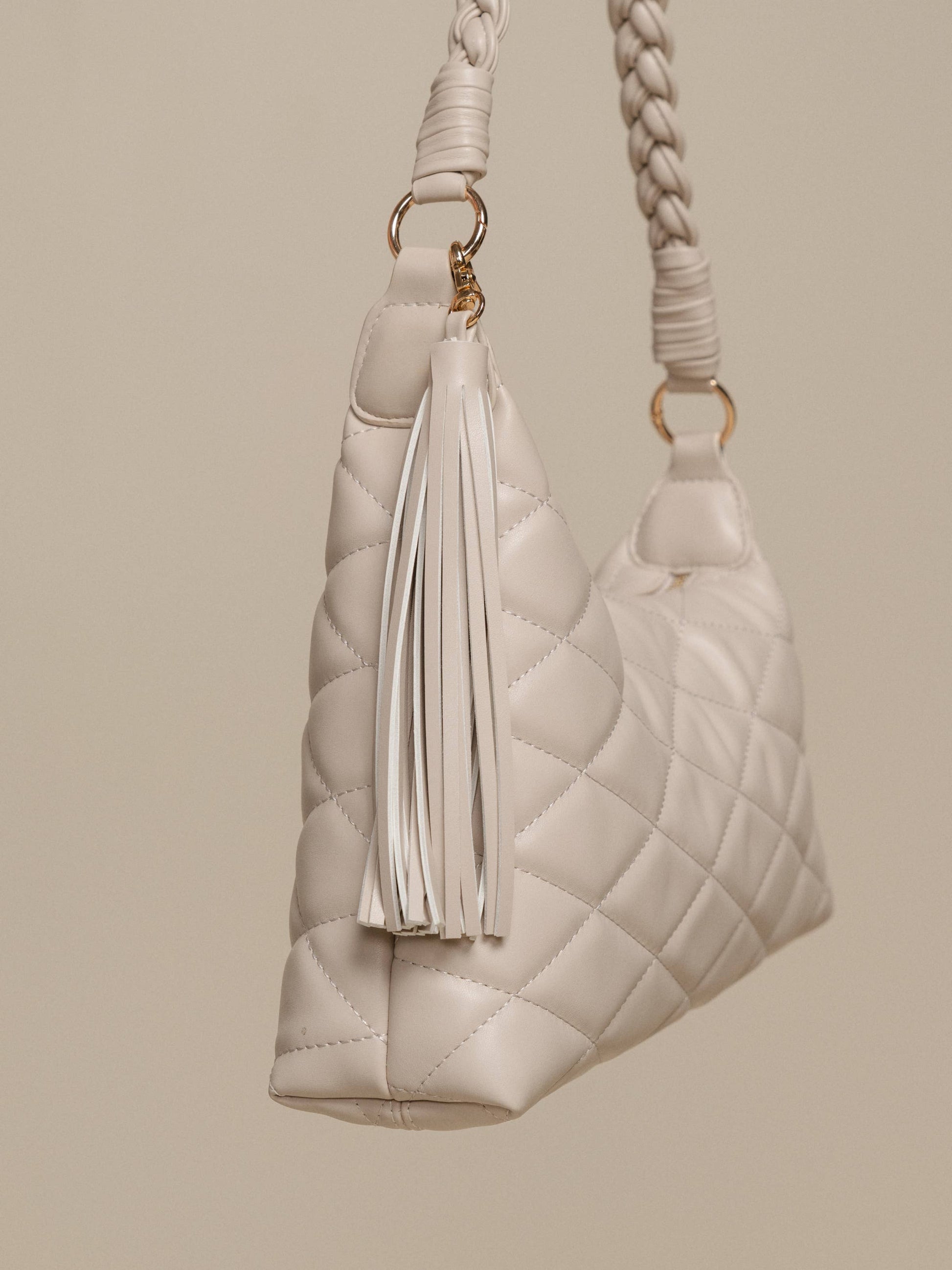 Borsa a spalla trapuntata in PU con manico intrecciato e nappina