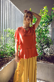 Pantaloni midi palazzo con bottoni laterali