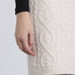 Gonna corta in maglia a trecce