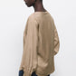 Blusa beige con scollo a V e dettagli di paillettes
