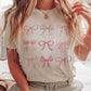 T-shirt grafica con fiocchi rosa