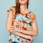 Camicia pareo multicolor con scollo a barca e bottoni sul retro