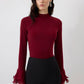 Blusa in maglia con maniche a balze in chiffon trasparente