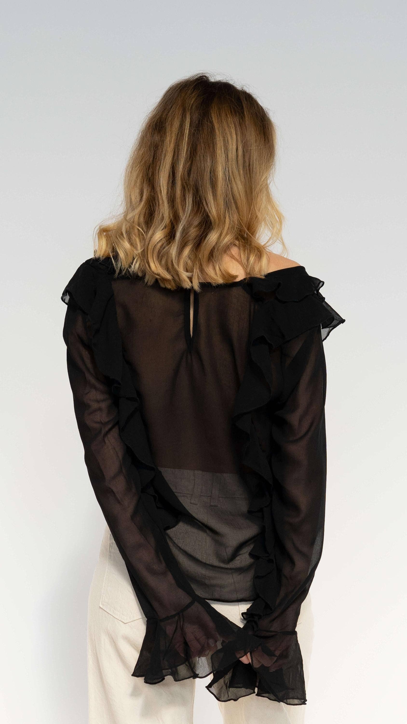 Blusa nera semitrasparente con volant