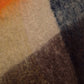 Poncho a quadri con frange