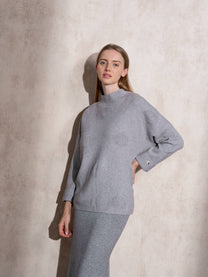 Maglione in maglia con motivo a pois e bottoni ai polsi