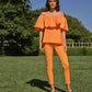 Top off-shoulder con volant in popeline
